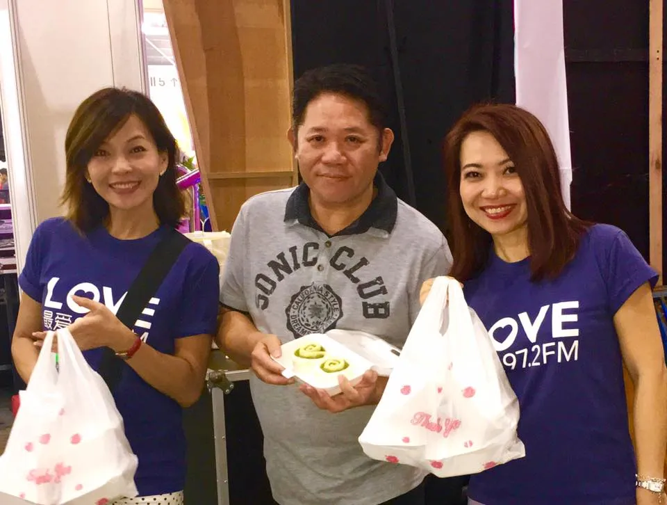 Lim Mei Jiao and companions in blue Love 972 shirts, holding bags of pau